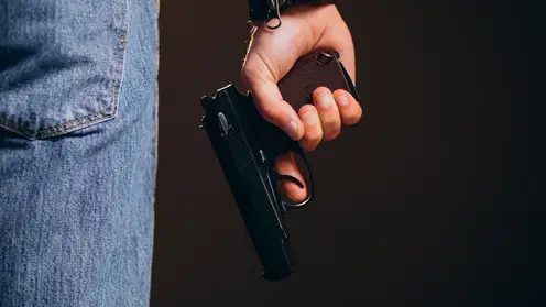 handsome-man-actor-posing-studio-with-weapon