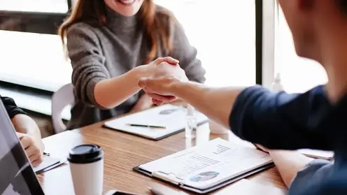 close-up-business-woman-shaking-hands-with-her-financial-partner-business-concept_160672-18272
